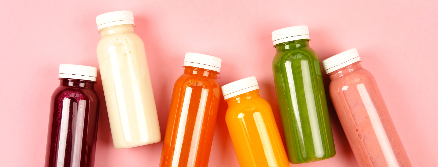 variety of coloured drinks in plastic bottles
