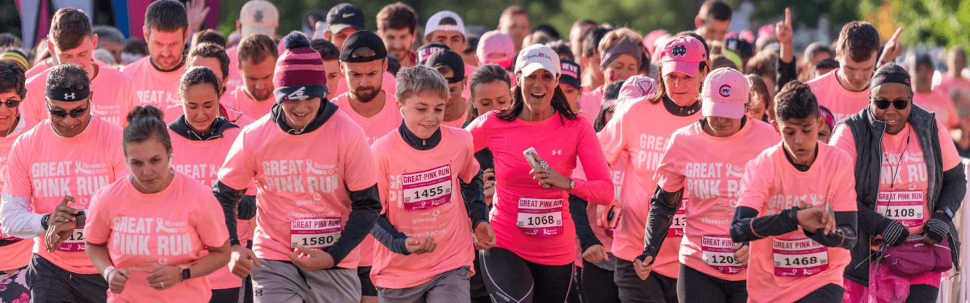 People running in the great pink run wearing great pink run t-shirts