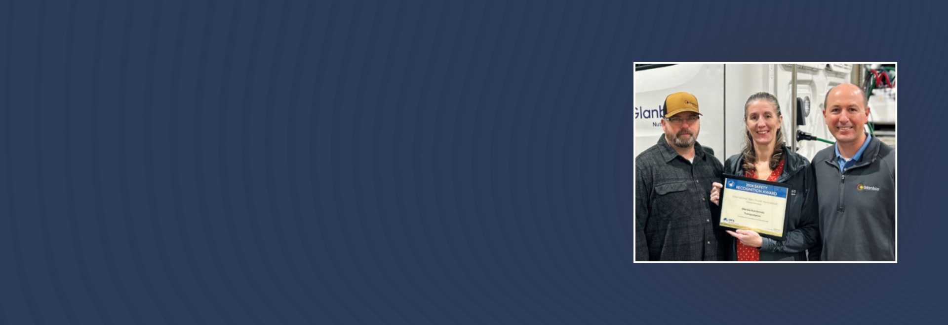 man, woman, man, all three standing with certificate