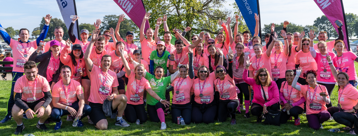 group of people wearing great pink run t-shirts and taking part in the run