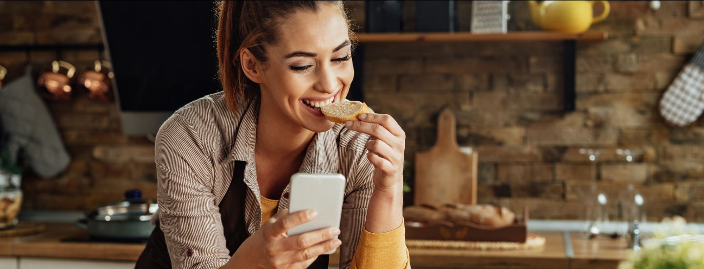 girl eating bread with phone